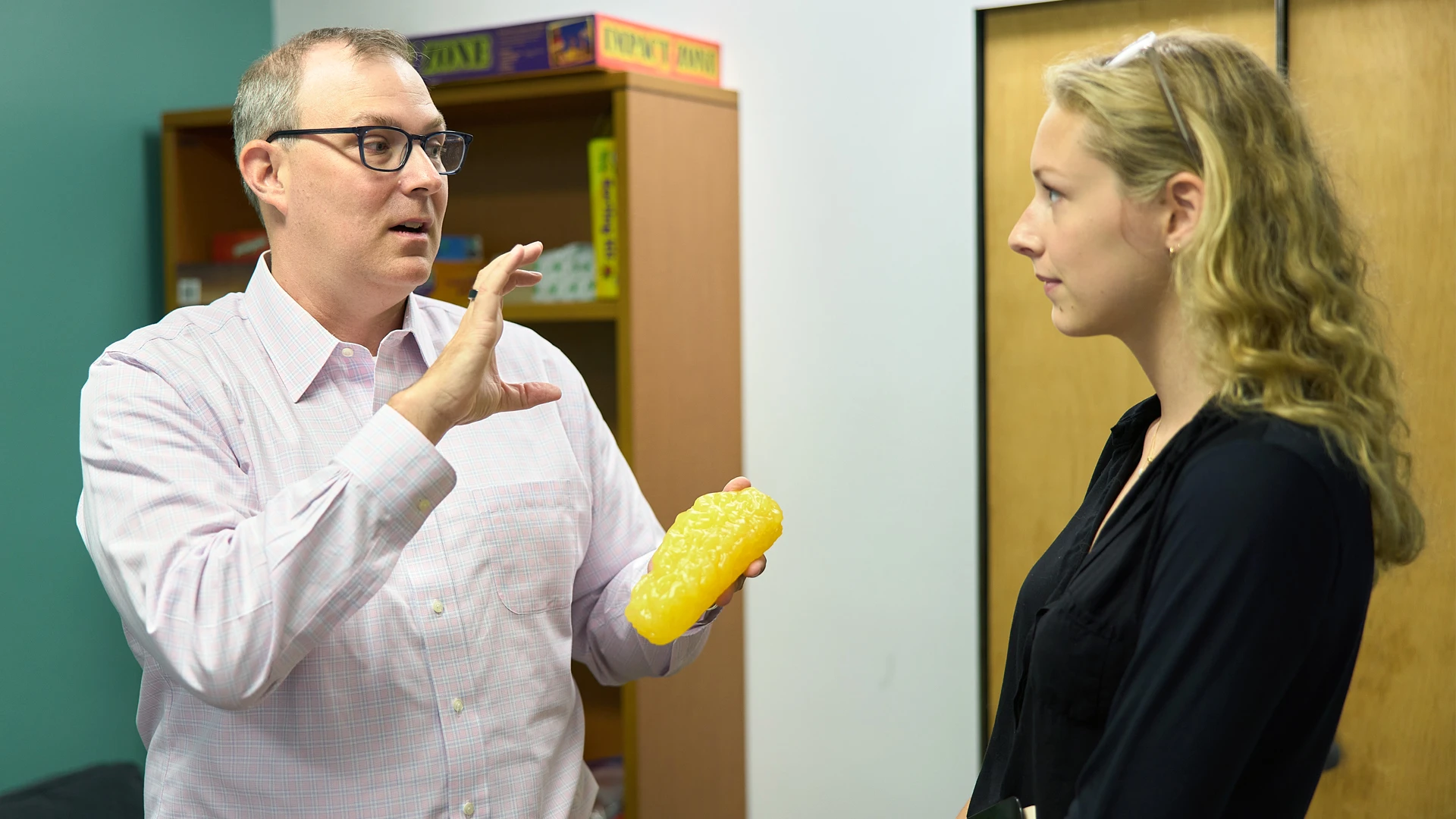 Dr. Hildebrandt (left) demonstrating to Webb (right) the use of a "blob," a gelatinous mass used in an intervention known as interoceptive exposure.
