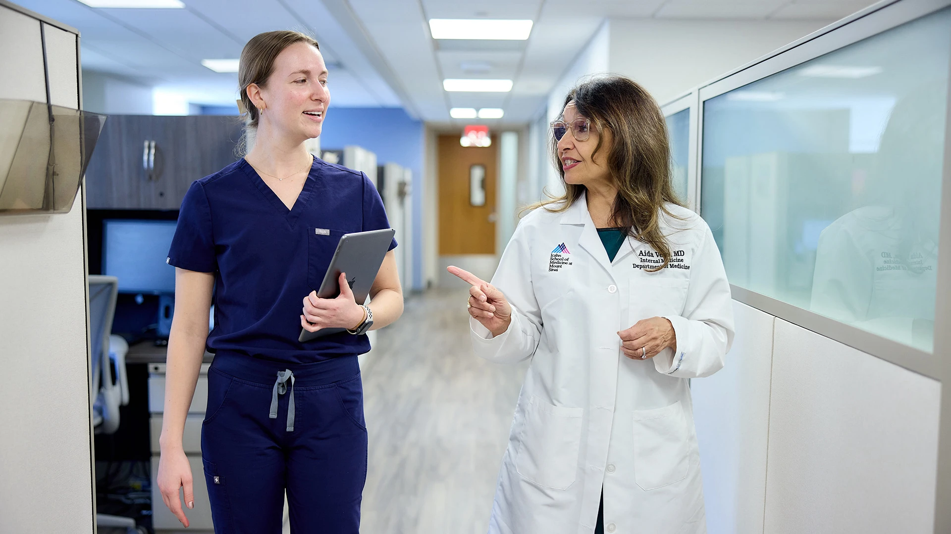 Miranda Veeser, NP, and Aida Vega, MD, on their way to see a patient