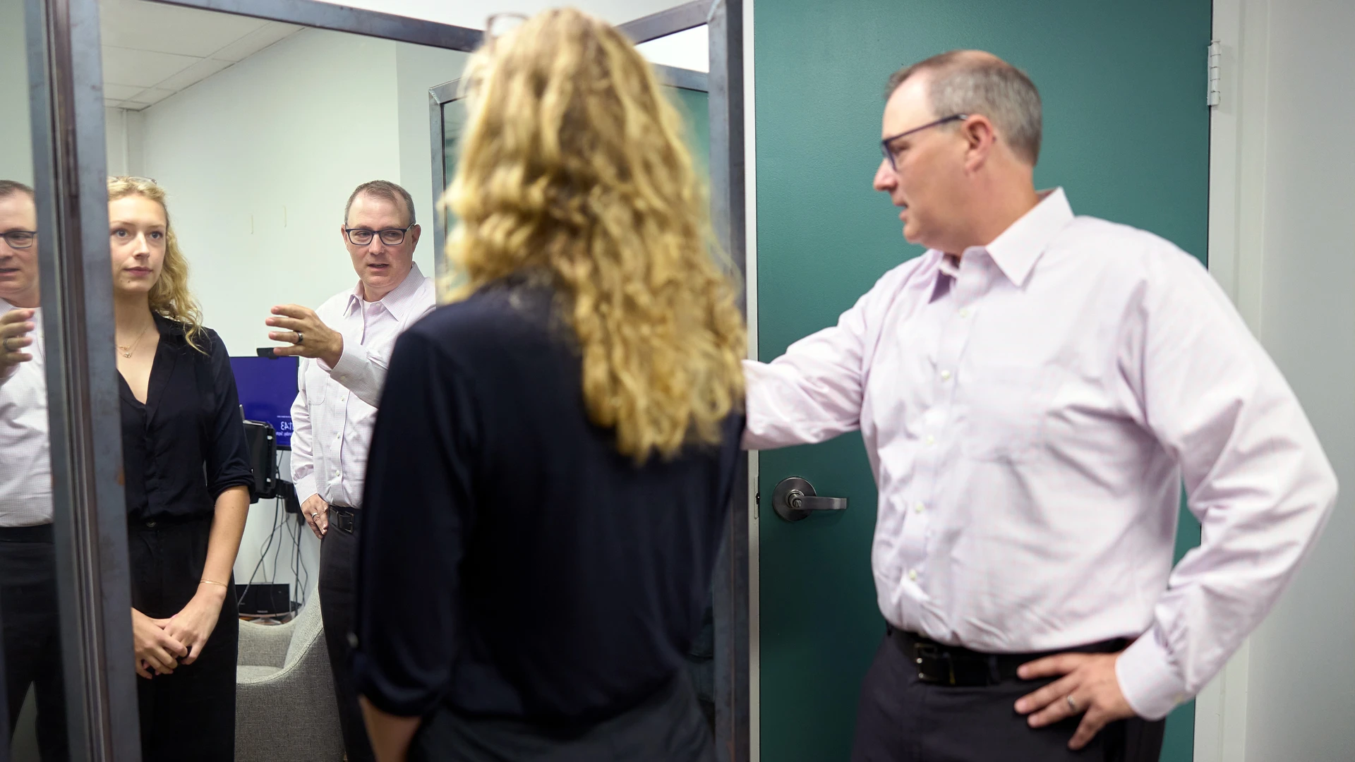 Dr. Hildebrandt (right) demonstrating to Webb (left) how to conduct acceptance-based mirror exposure therapy, in which patients learn to overcome negative body image.