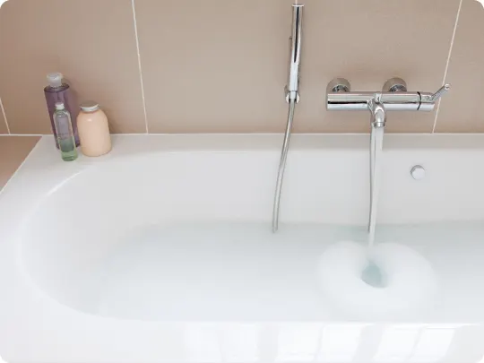 bathtub filling with water and bubble bath