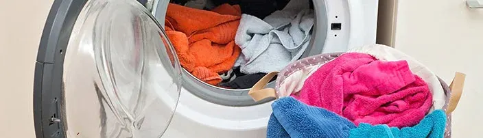 washing machine with laundry inside and outside