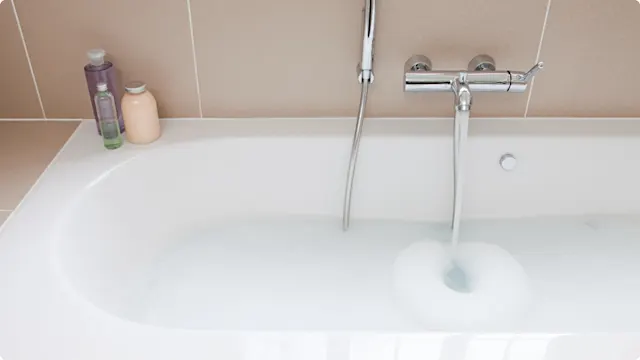 bathtub filling with water and bubblebath