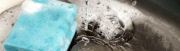 soapy sponge in a kitchen sink