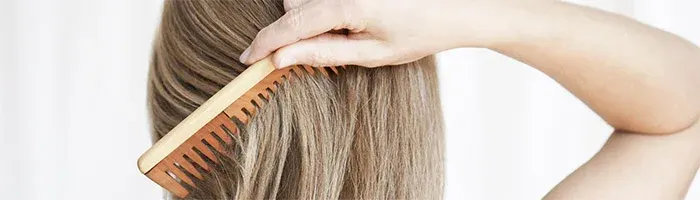 woman combing her hair