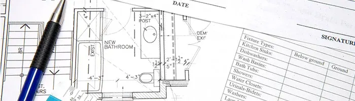 pencil on top of blueprints and contract