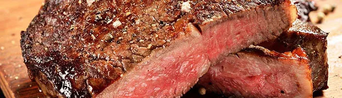 cooked steak cut open to reveal inside