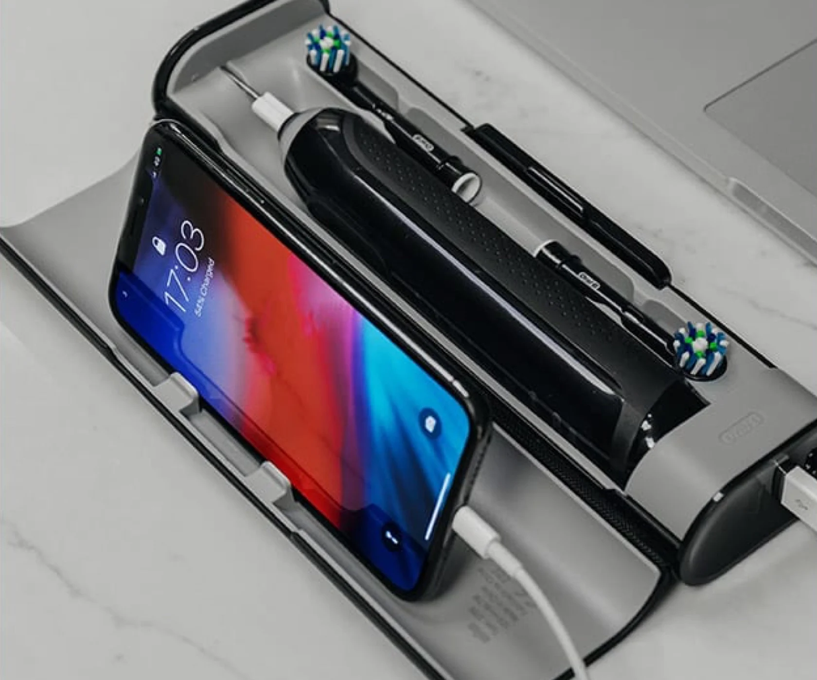 Premium travel case charges the Genius X brush and a phone at the same time undefined