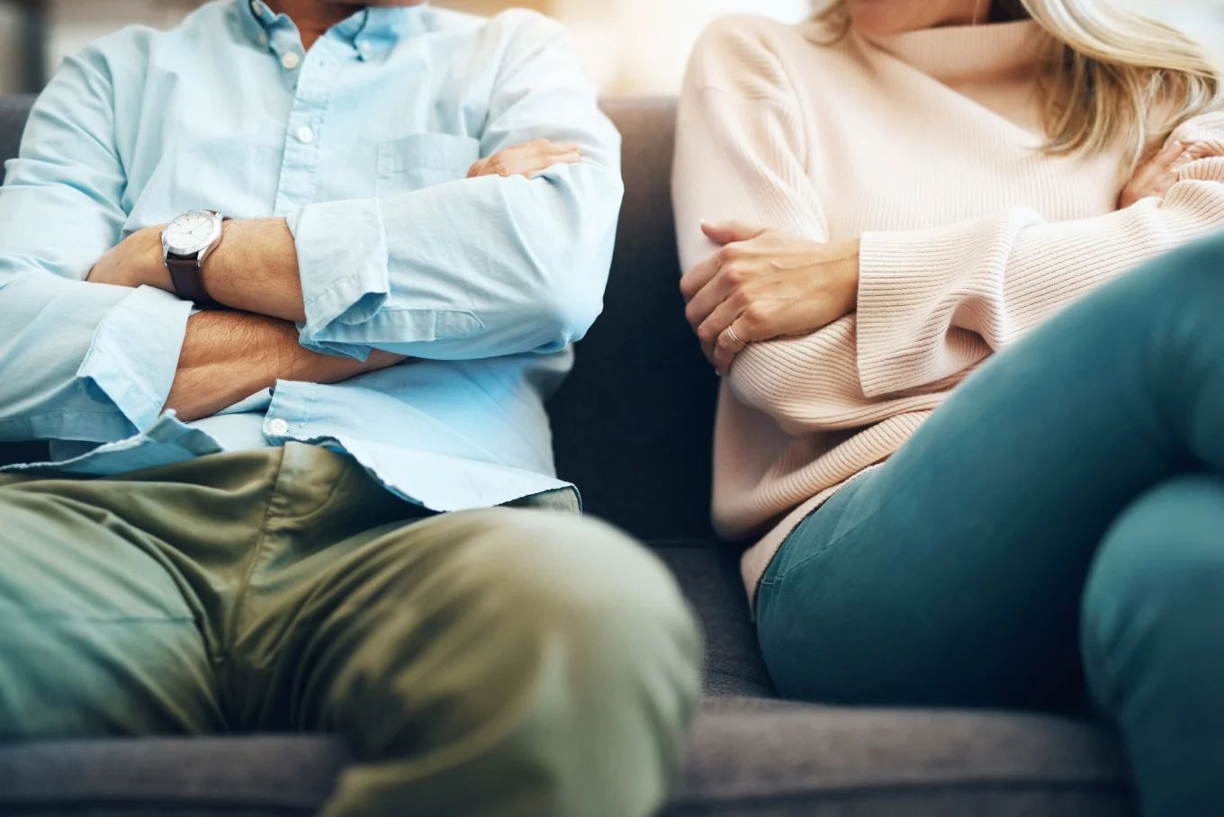 man and woman sitting with crossed arms