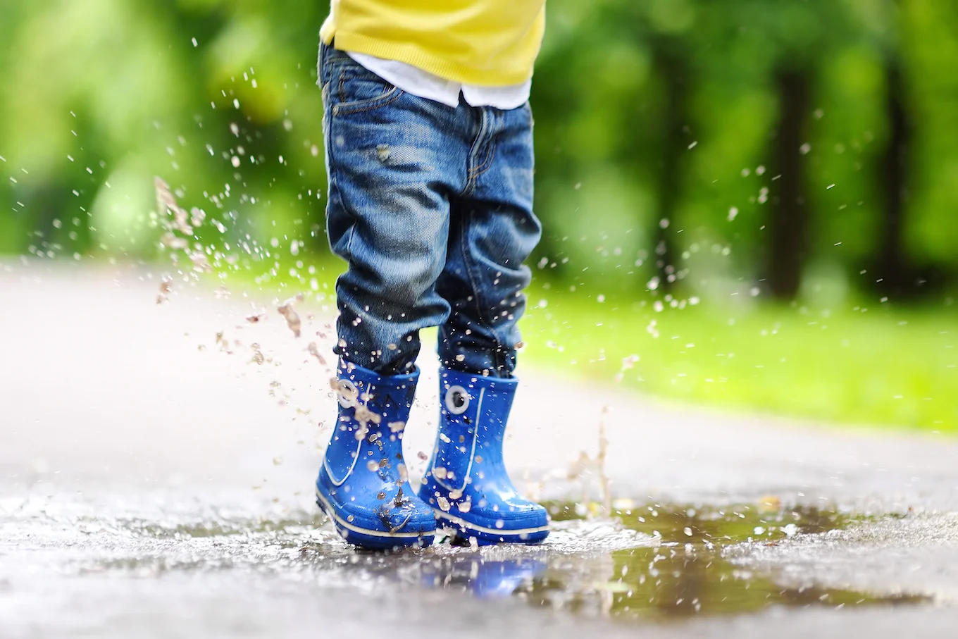 toddler jumping in puddle