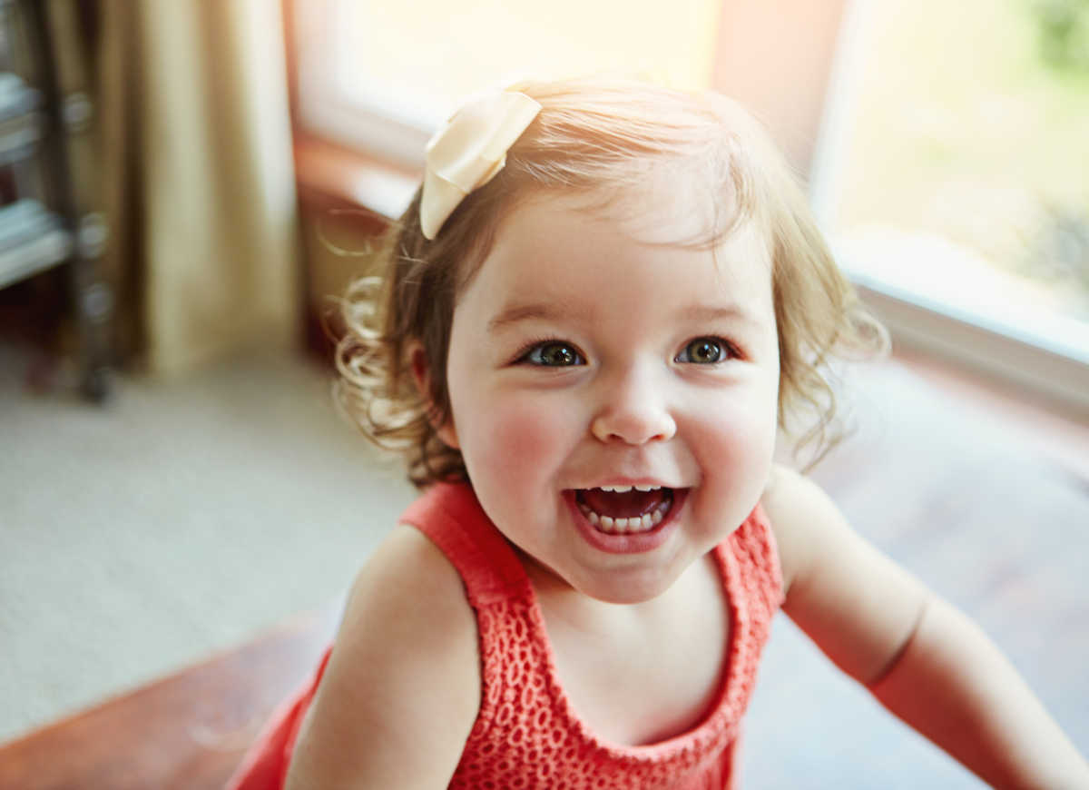 smiling baby girl with bow in her hair
