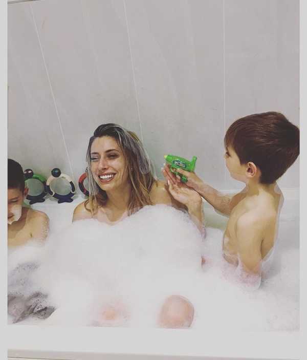 Mom taking a bath with her boys. 