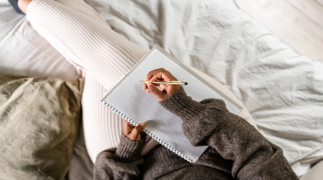 a closeup of a woman writing things down