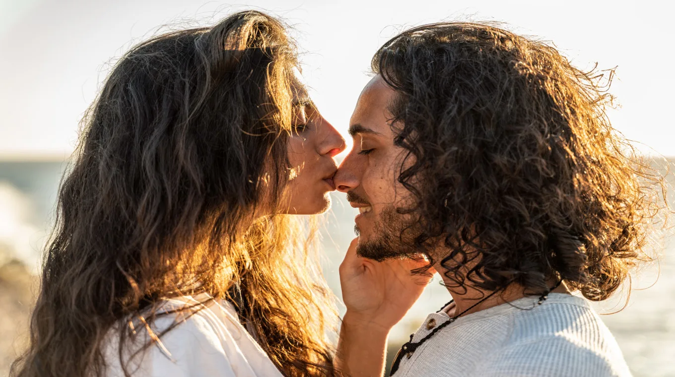 woman kissing a man on the nose