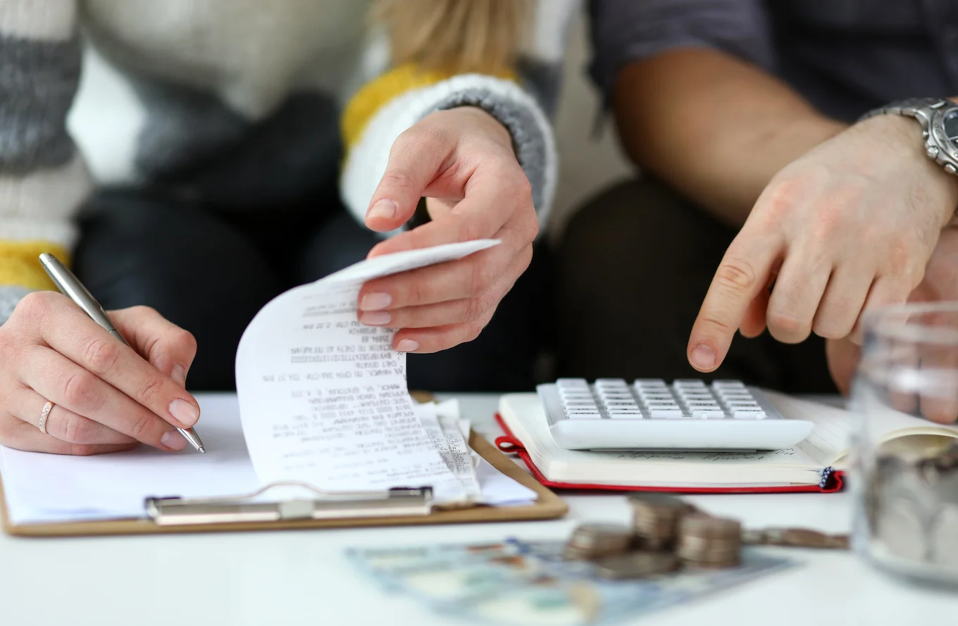 man and woman calculating budget