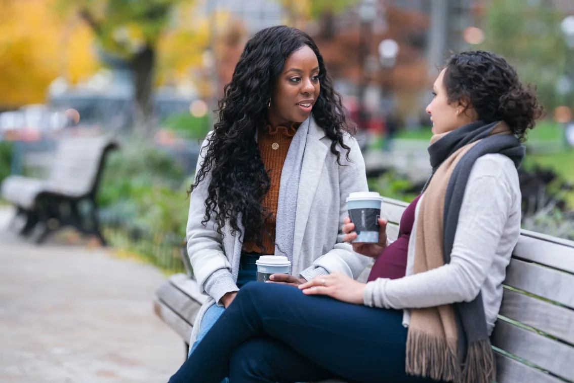 Women talking on a park bench