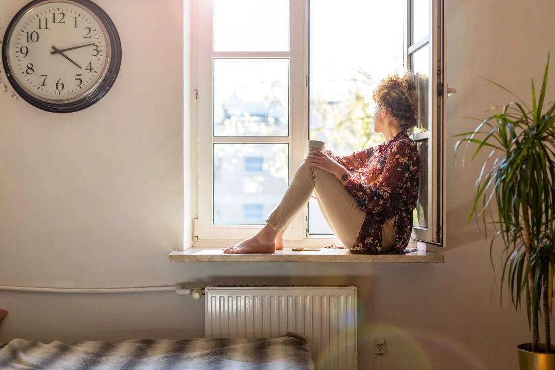 Woman looking out window