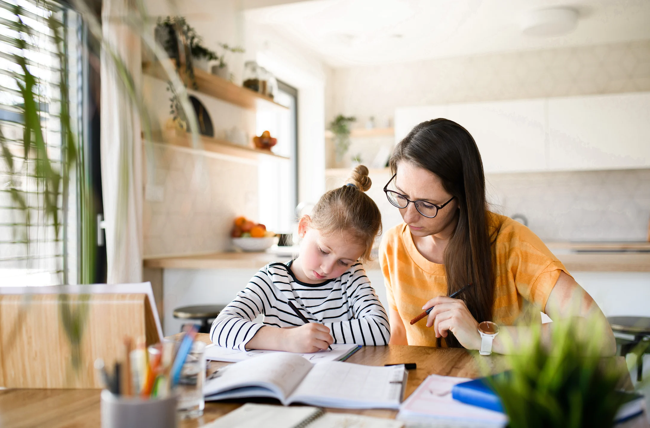 mom helping kid with schoolwork