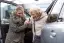 woman helping older woman from vehicle-placeholder