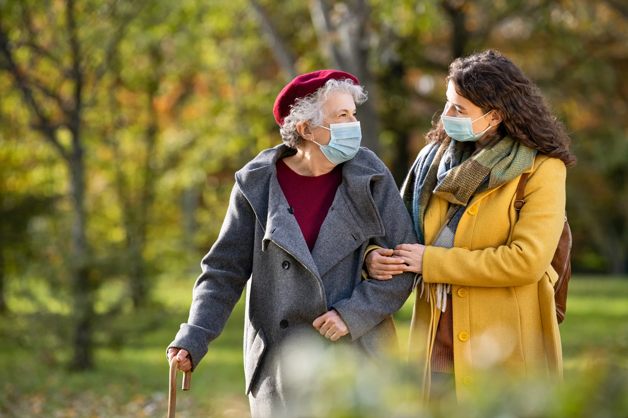 woman helping elderly woman