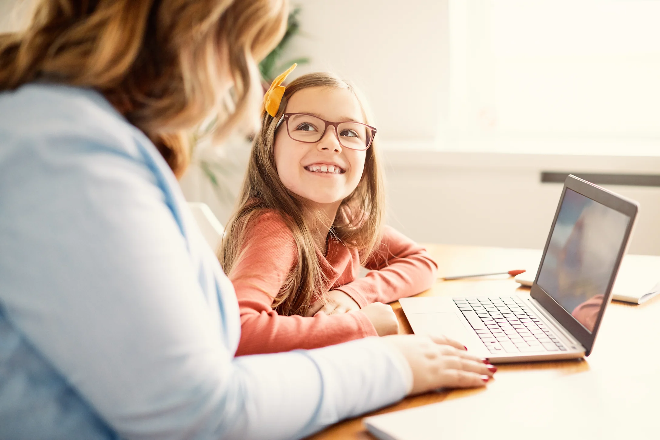 mom helping daughter with remote learning