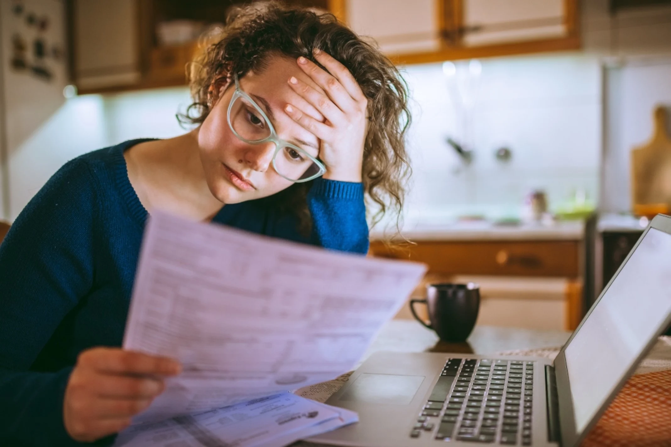 Stressed woman looking at bills