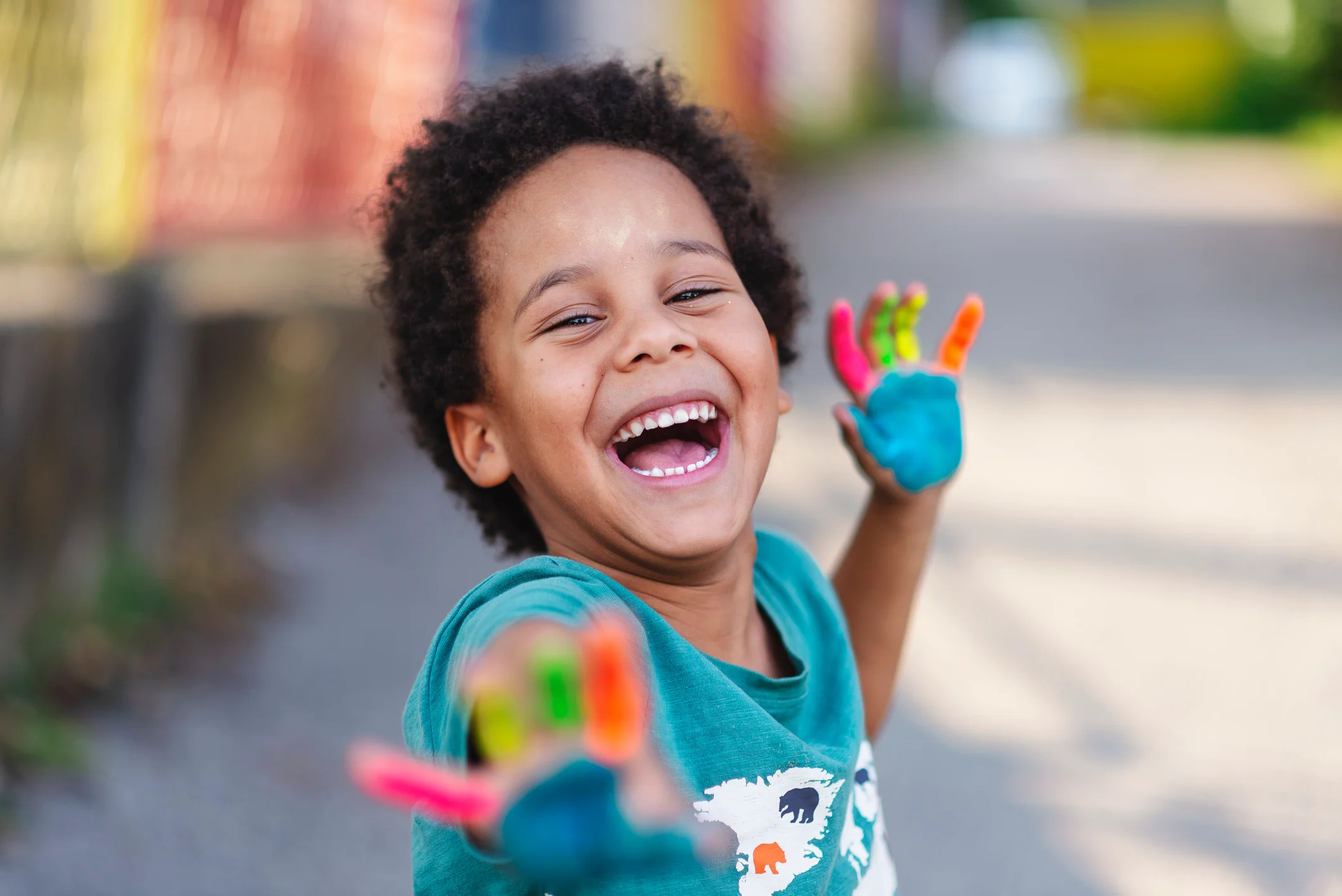 little boy with paint on hands