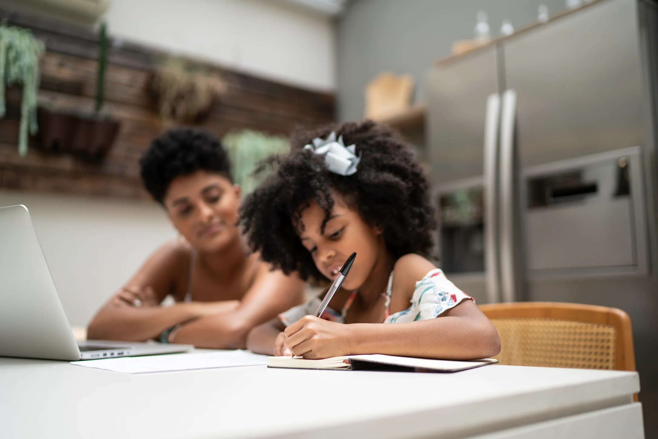 mom helping daughter remote learning school