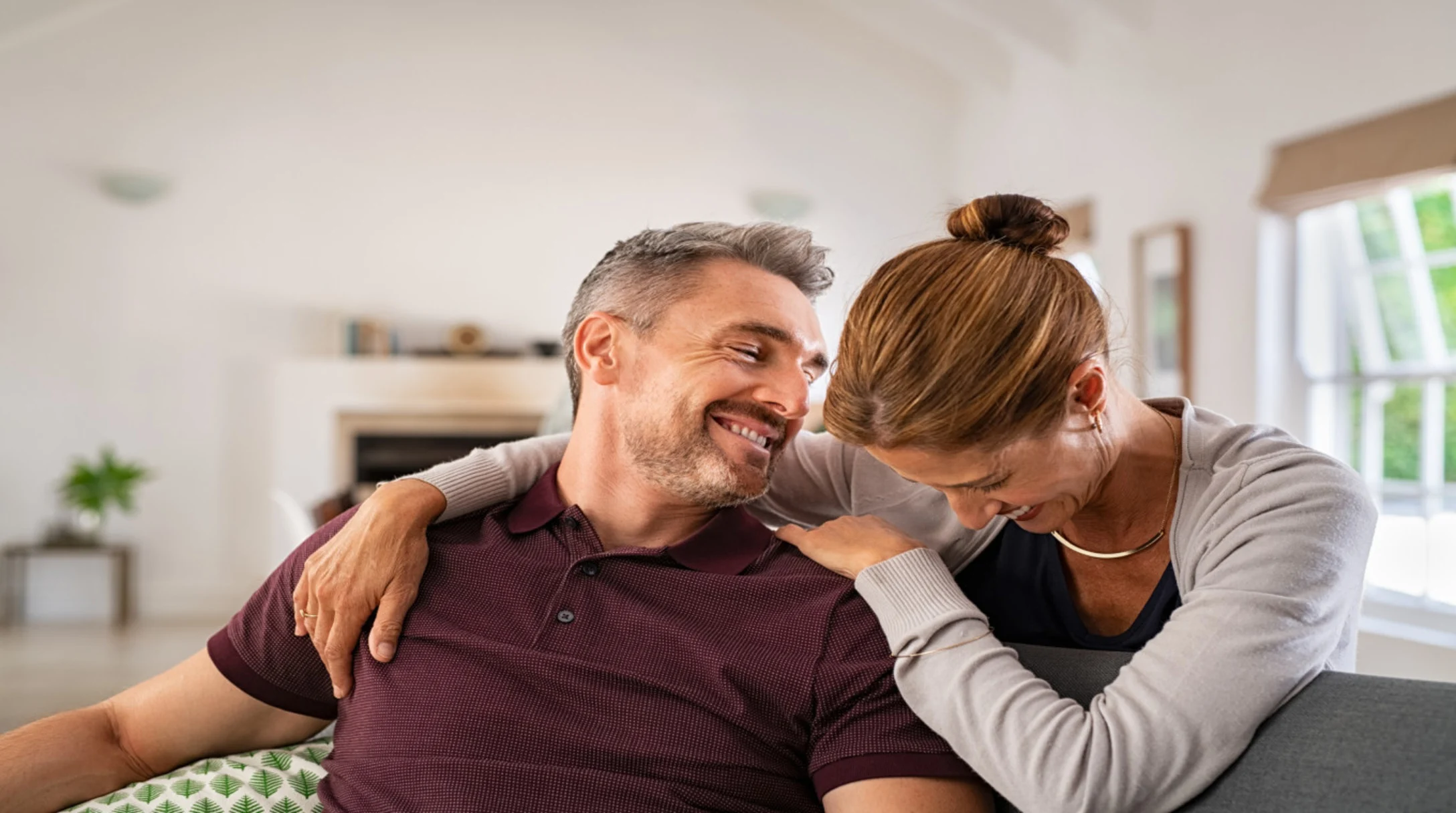 Couple laughing on the couch