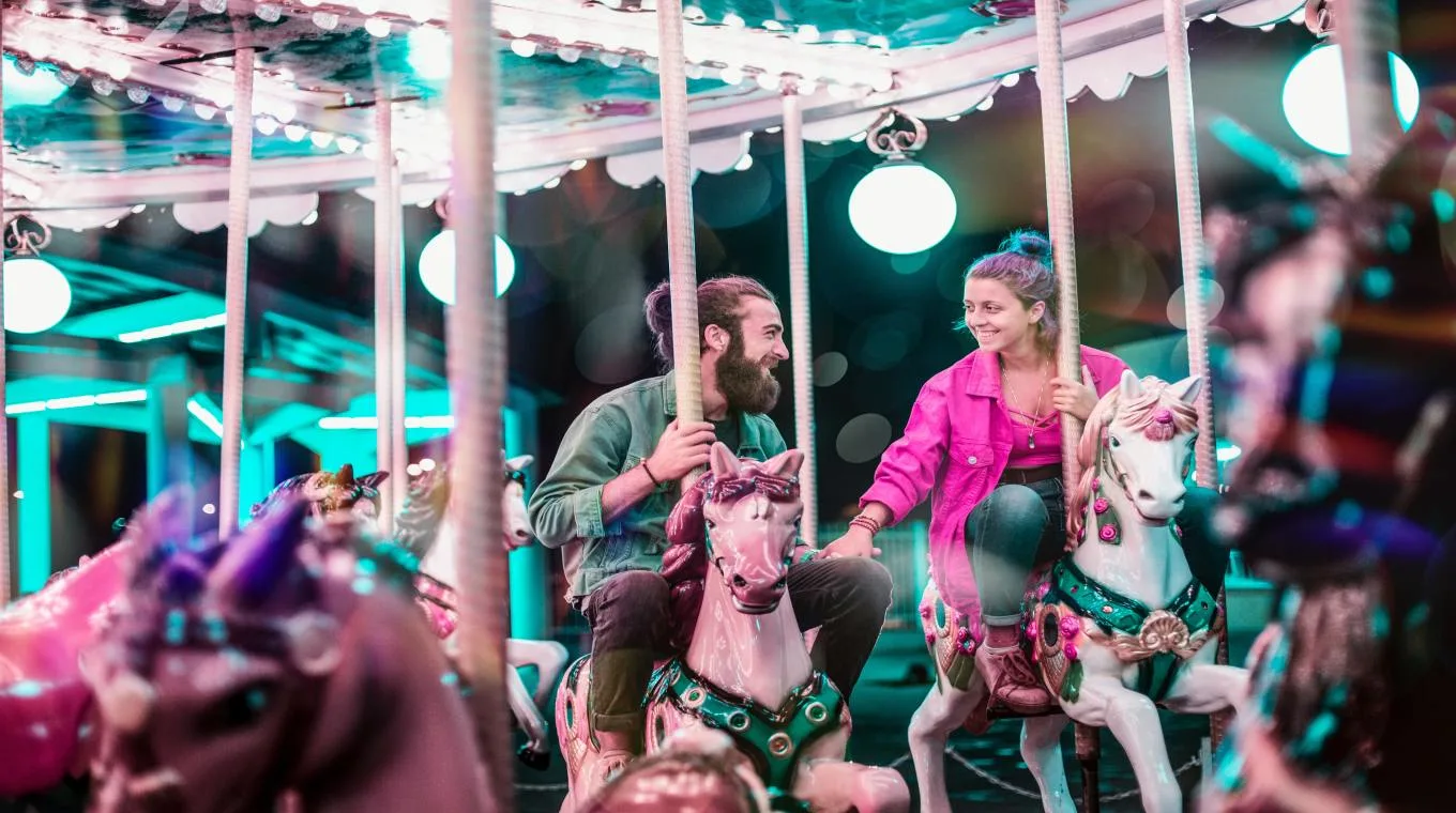 A couple riding a carousel