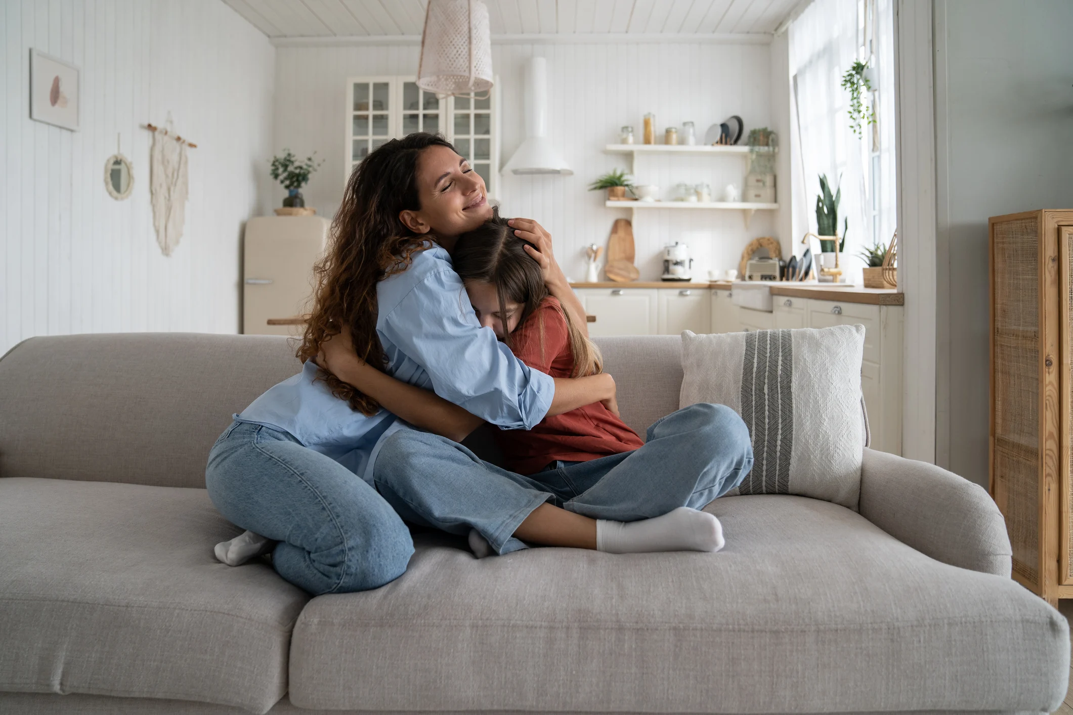 Mom and teen daughter hugging