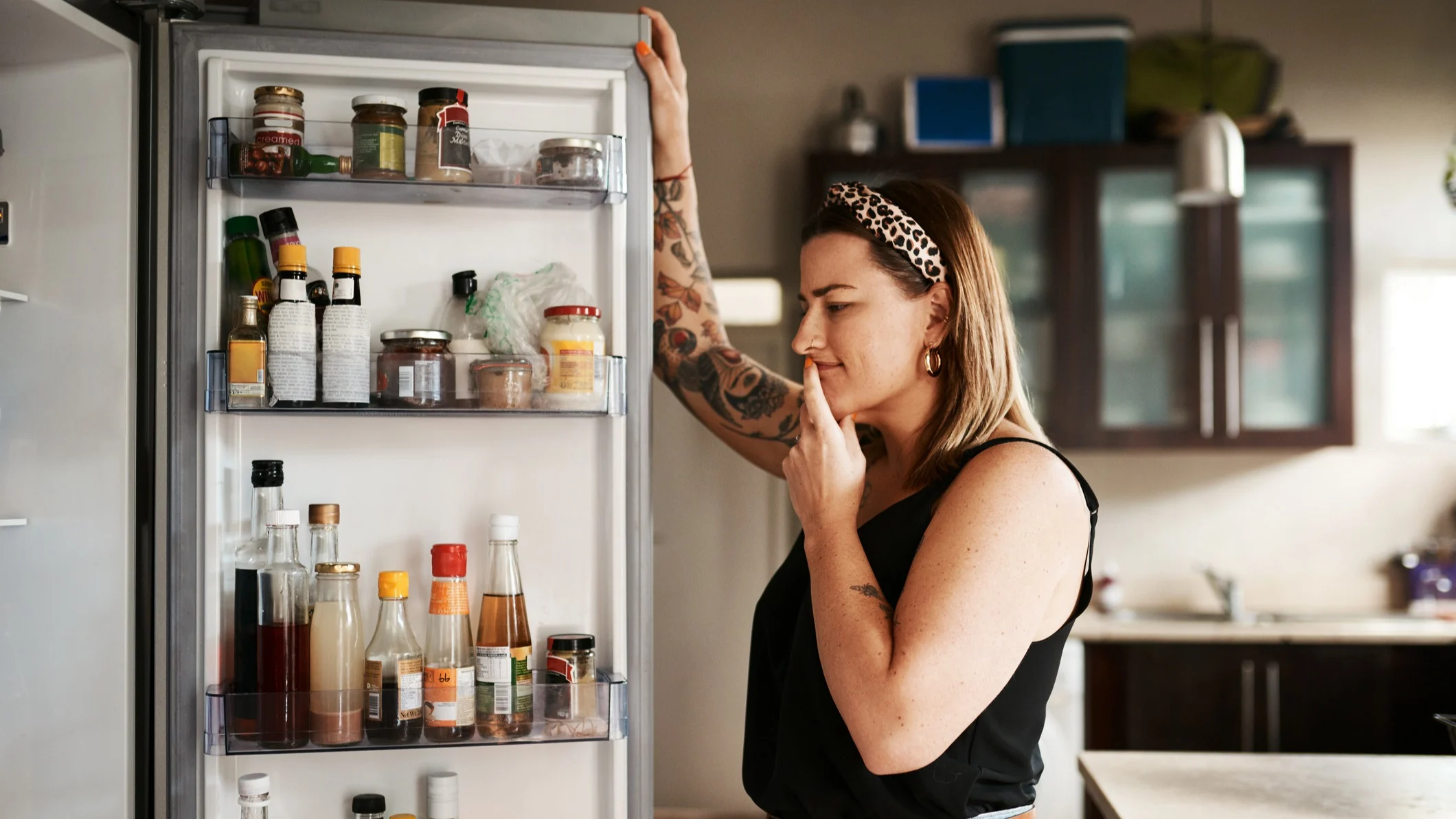 A woman looking at the fridge