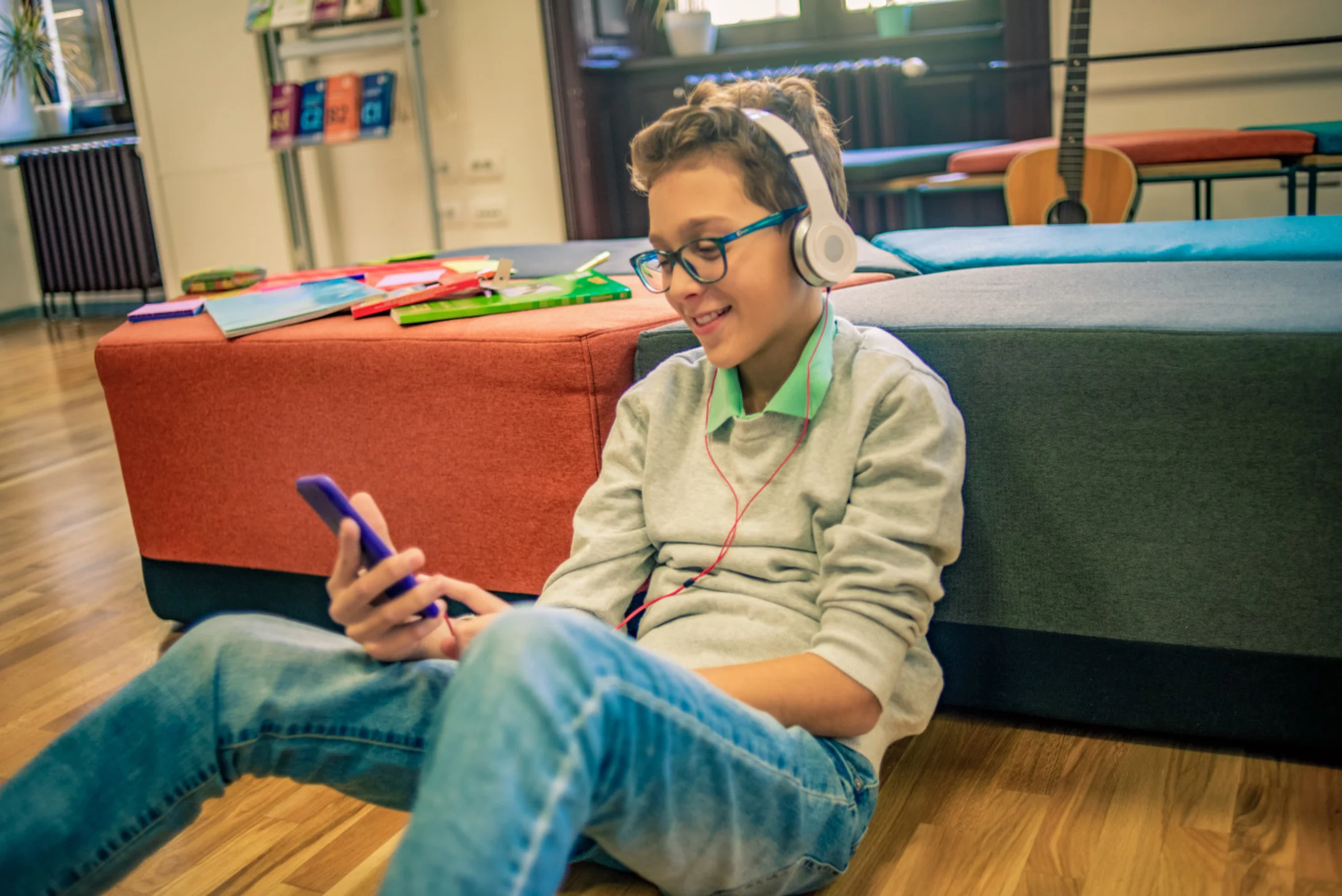 teen boy on phone wearing headphones