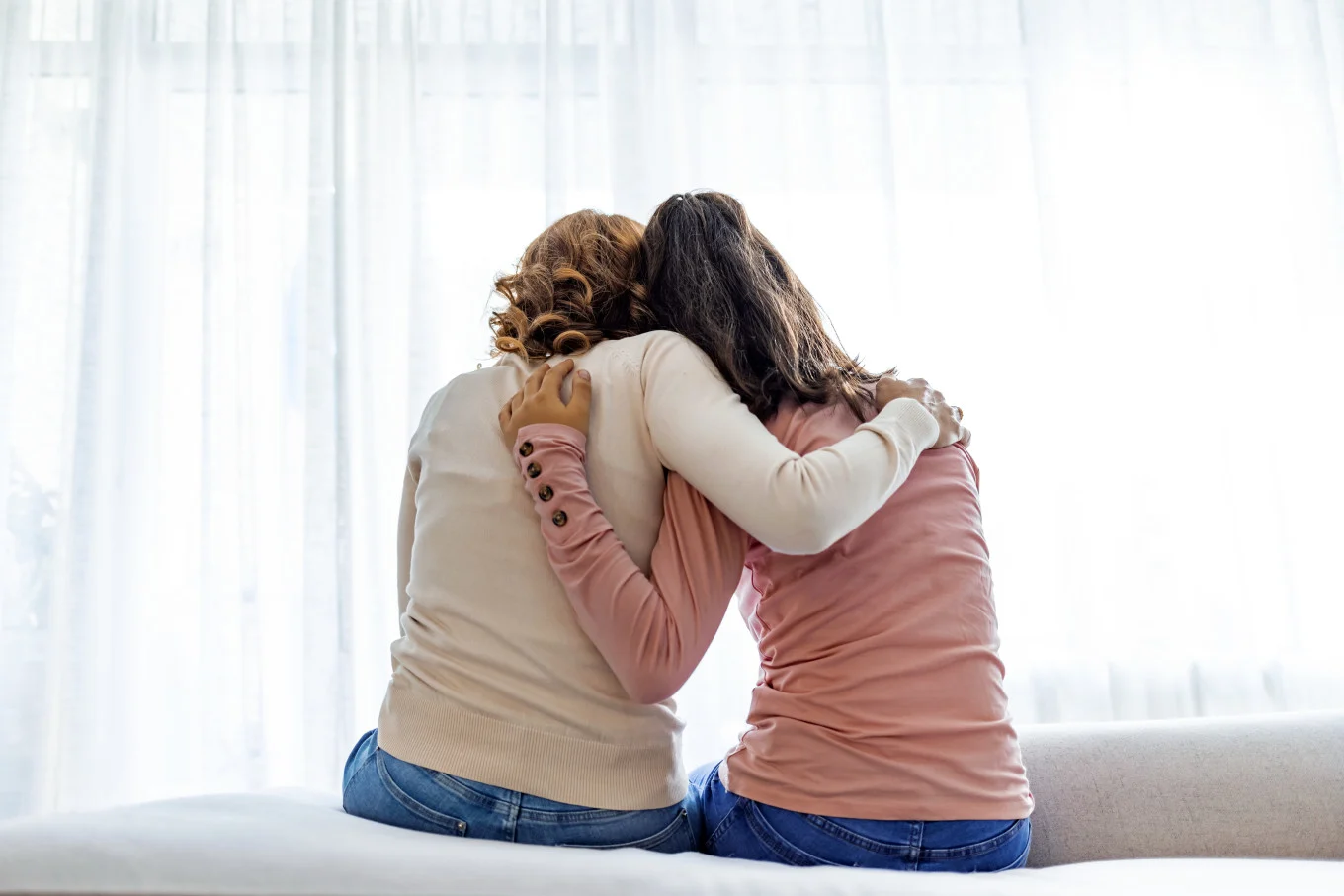 mom and daughter hugging