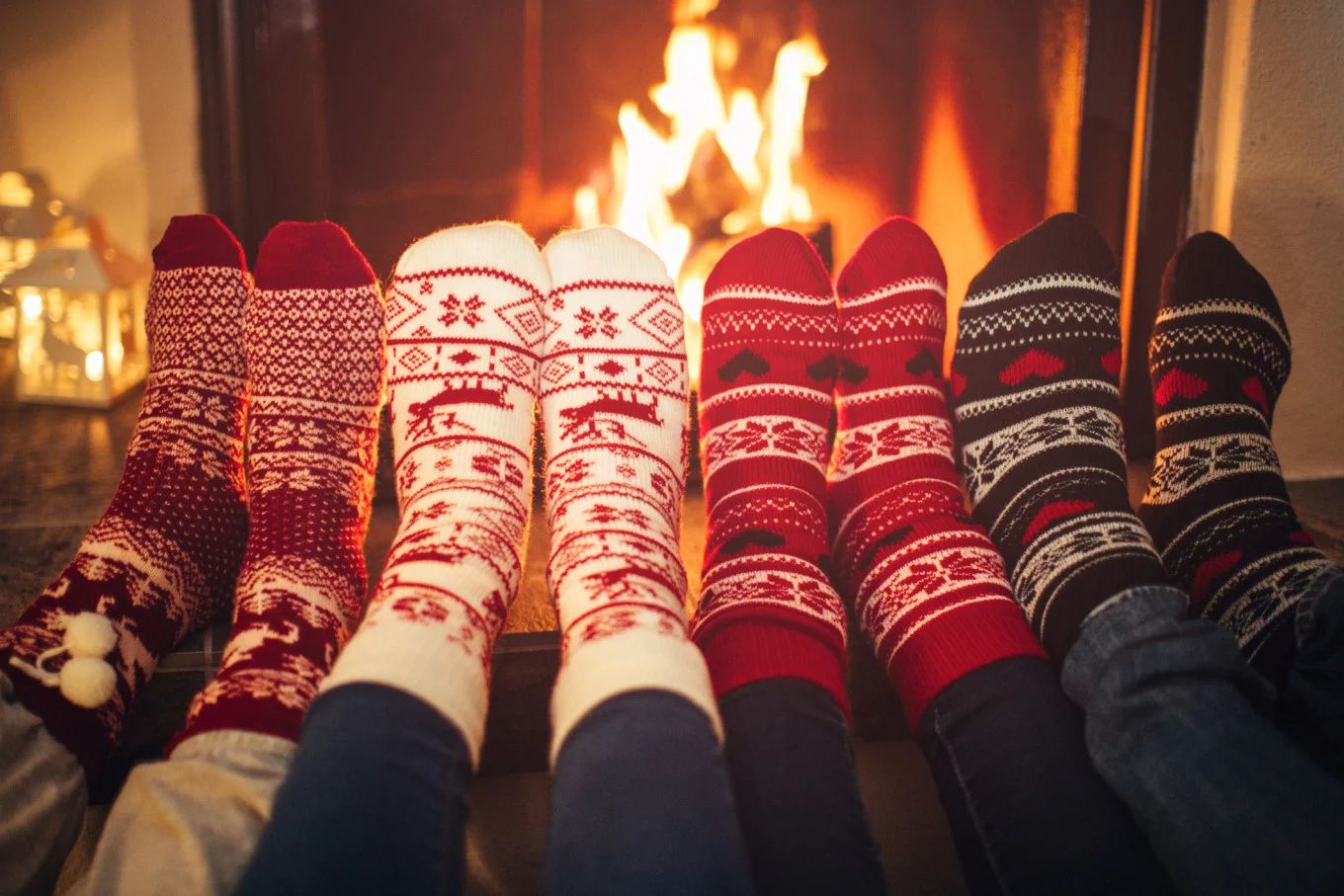 people wearing socks by fireplace