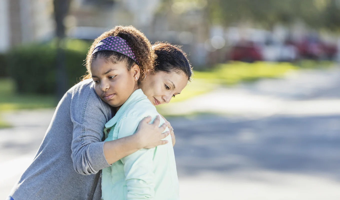 mom and daughter hugging