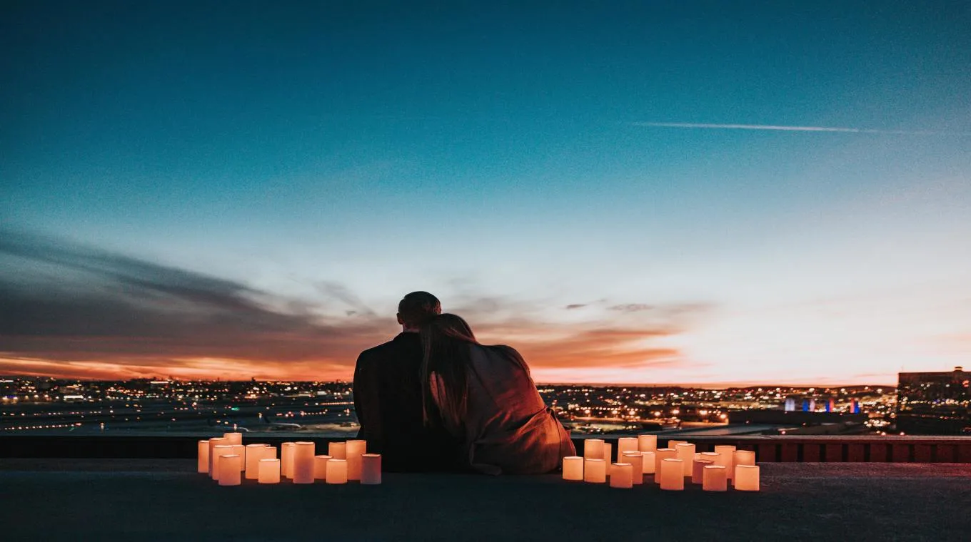 A couple looking at the skyline around candles