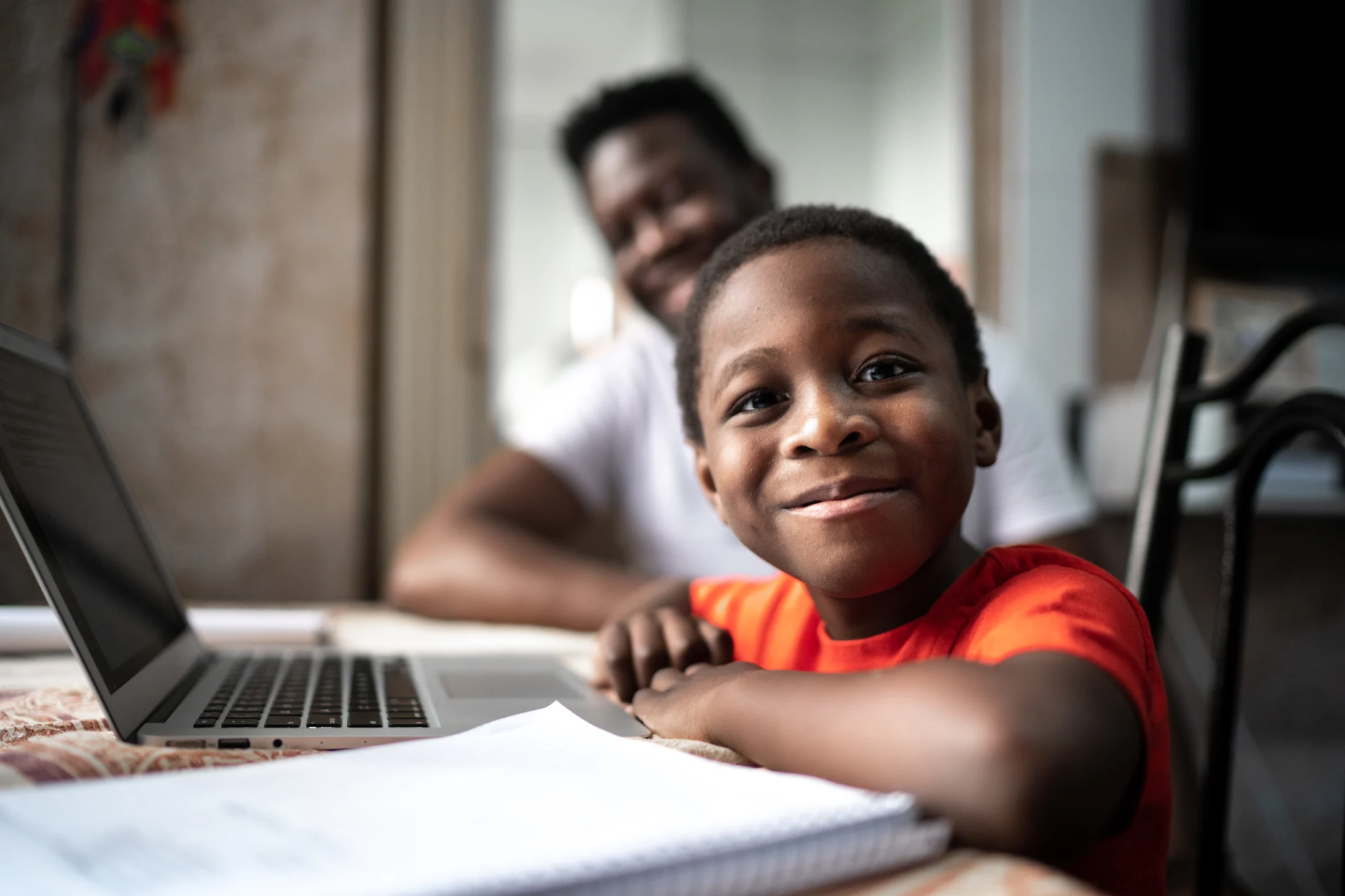 dad helping son with remote learning