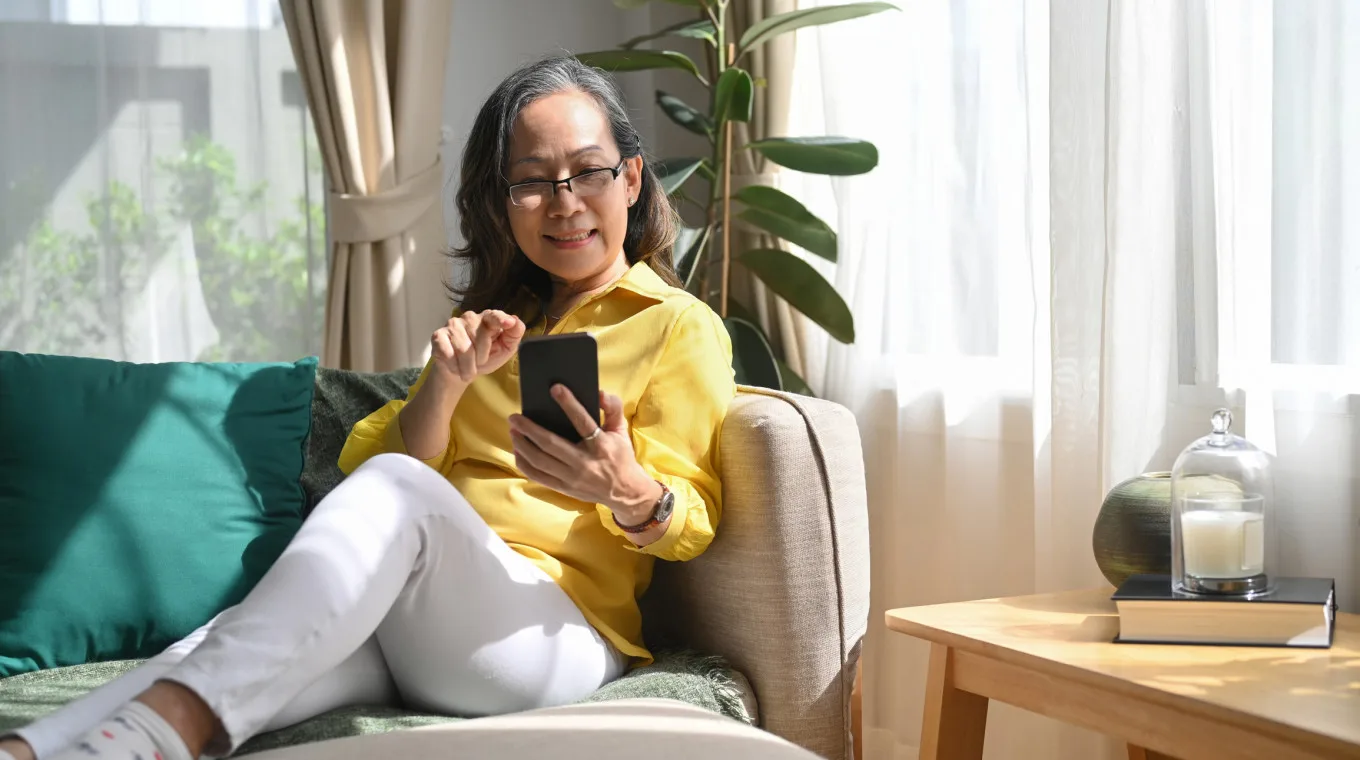 Asian woman on the couch on the phone