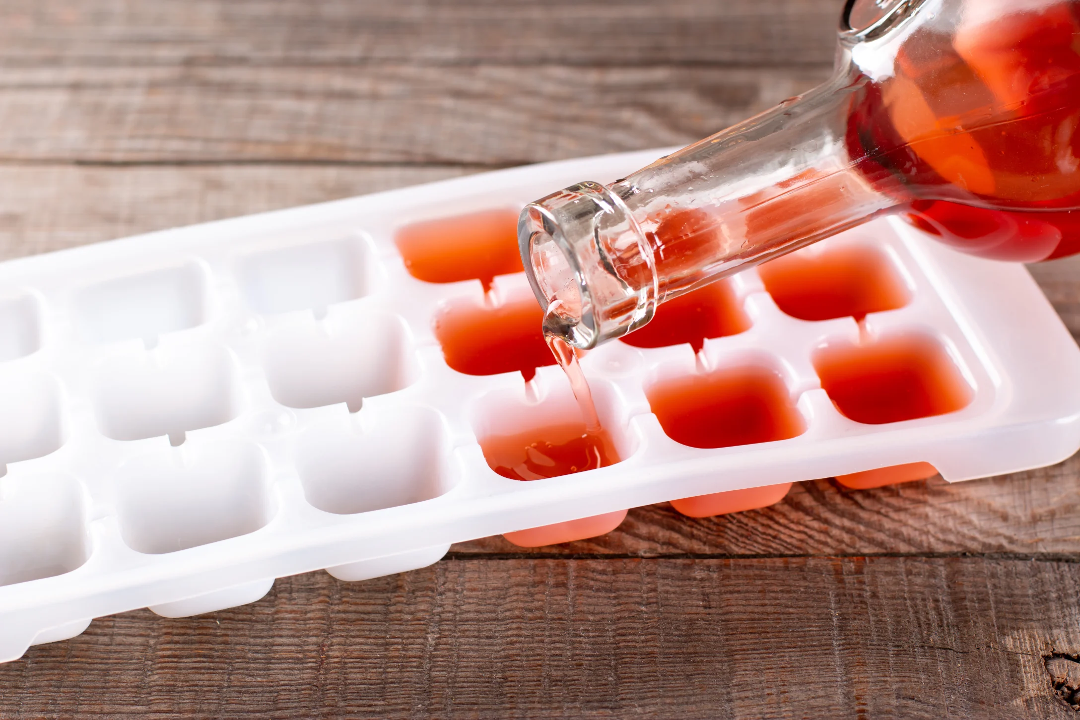 pouring wine into ice cube trays