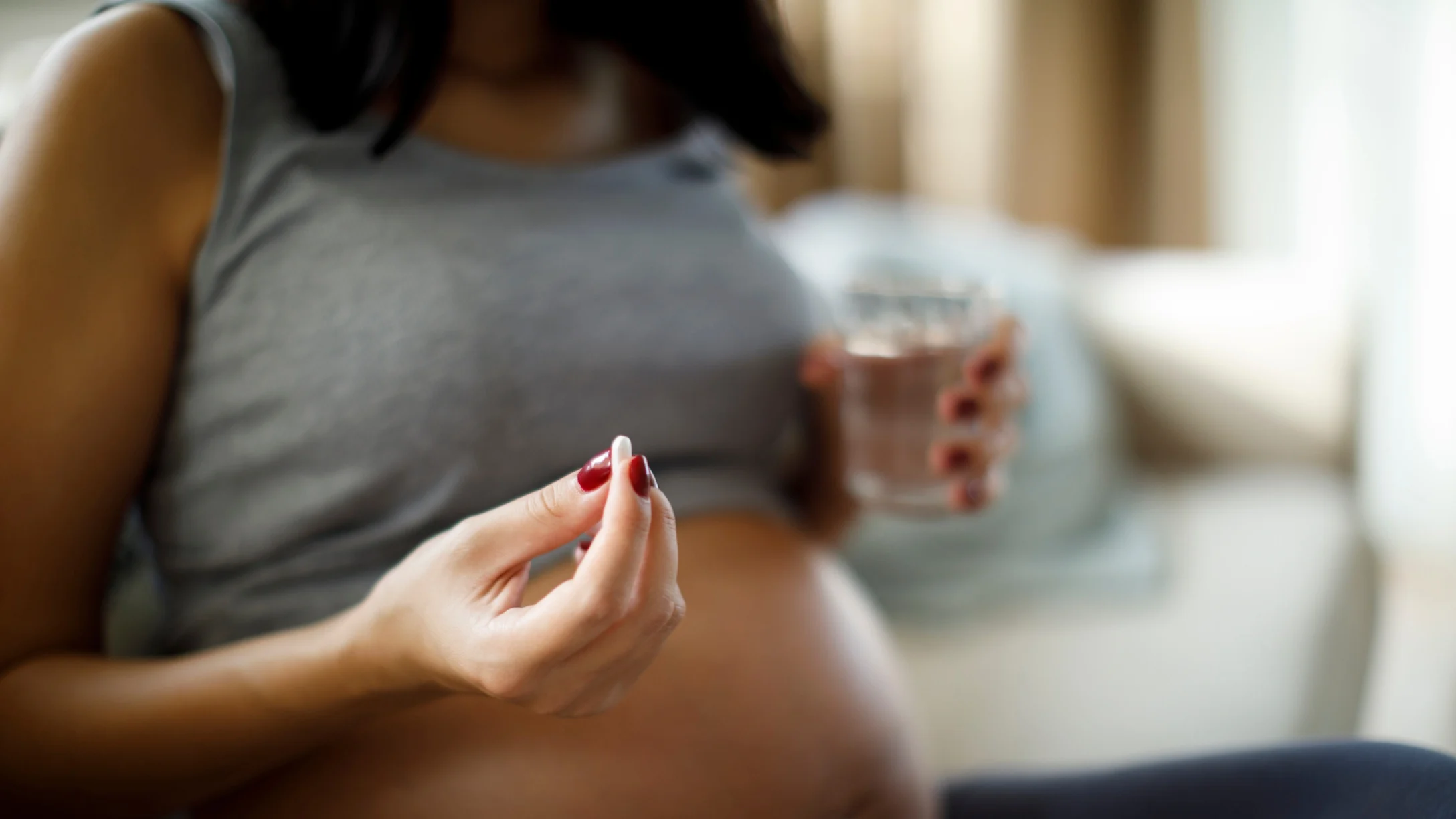 Pregnant woman about to take supplement