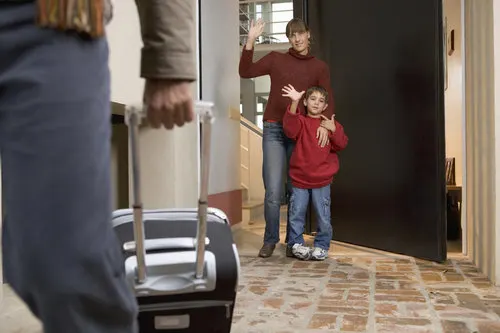 mom and son waving to dad traveling