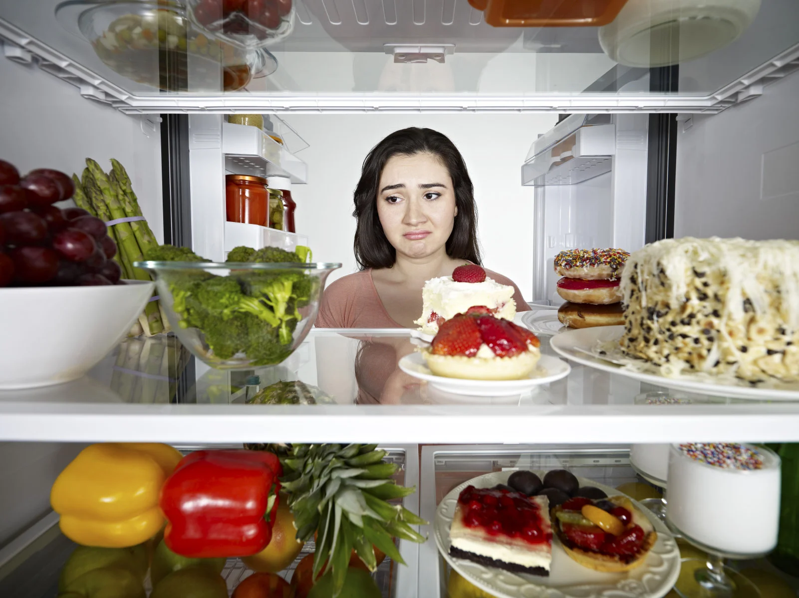 woman frustrated looking in fridge