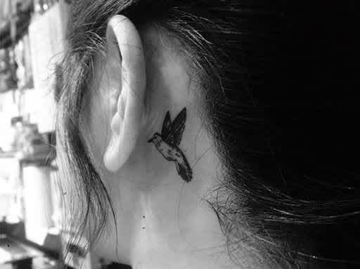 bird tattoo behind ear meaning