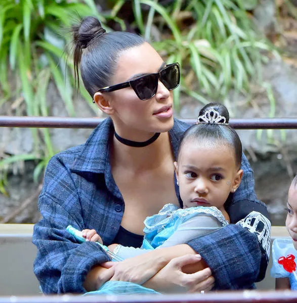 Kim Kardashian holding North