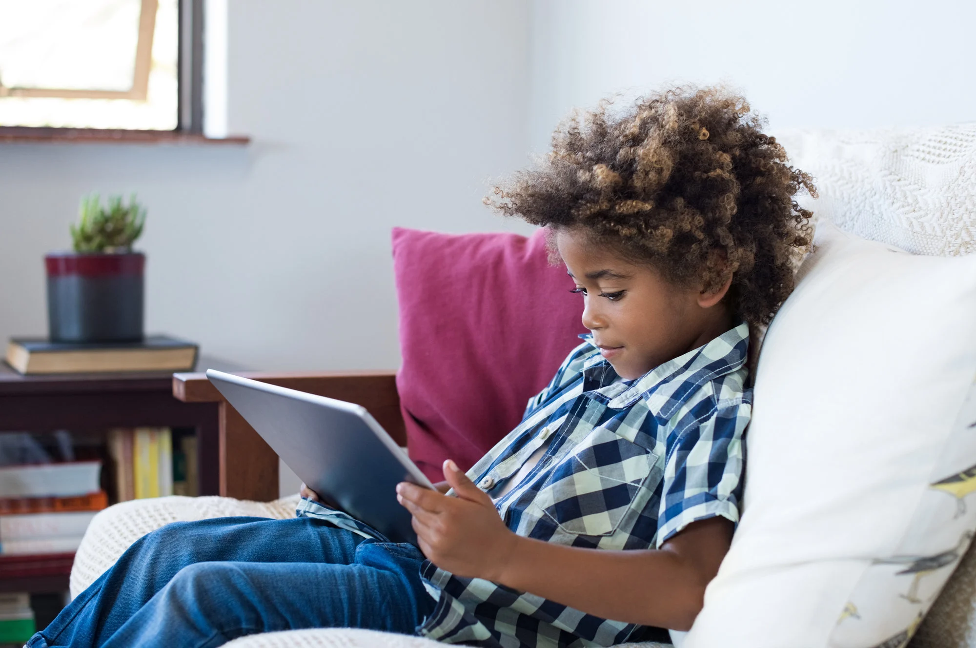 kid playing on tablet