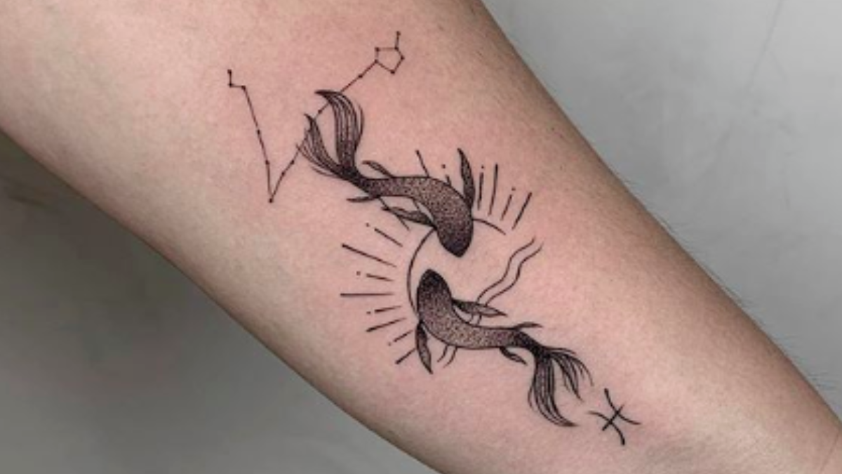 Watercolor pisces constellation tattoo on the bicep