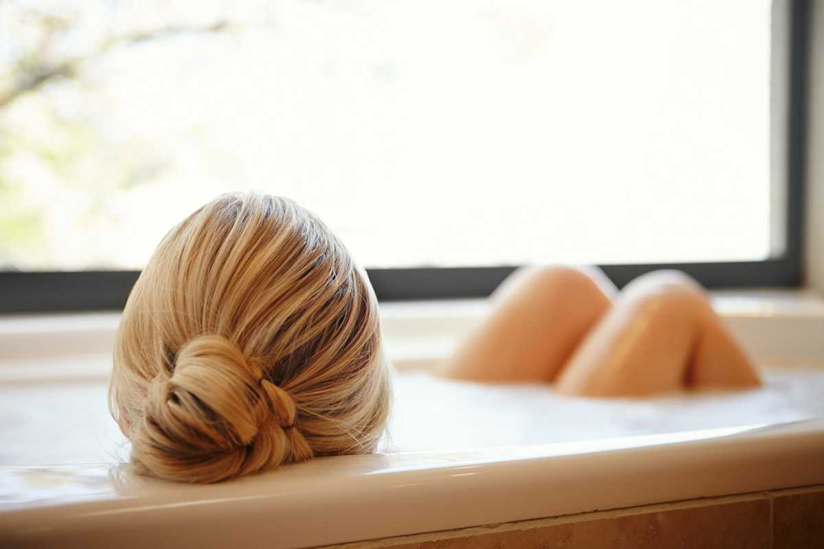 Woman soaking in bathtub
