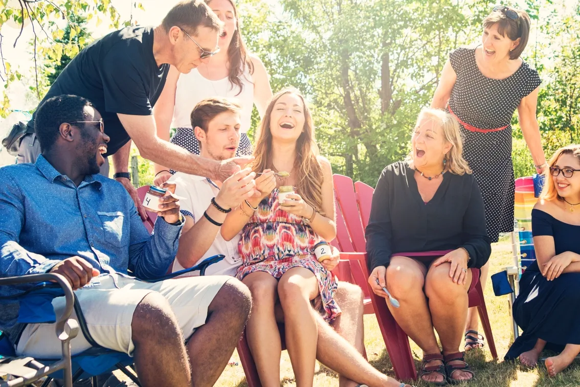 Men and women laugh at a co-ed baby shower