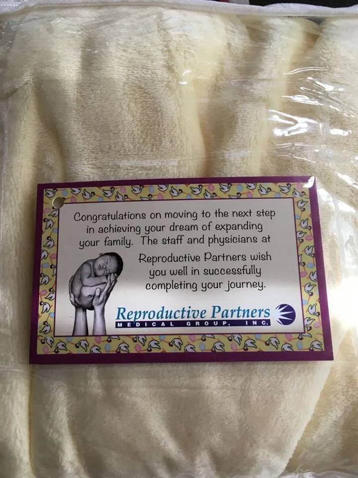 The fertility clinic gave them a graduation blanket before they left.