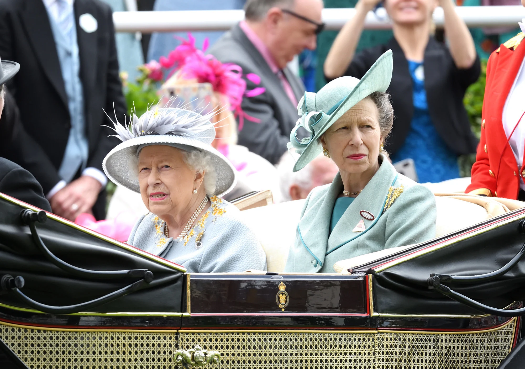 Queen Elizabeth shared a similar grimace in her own carriage for the event.